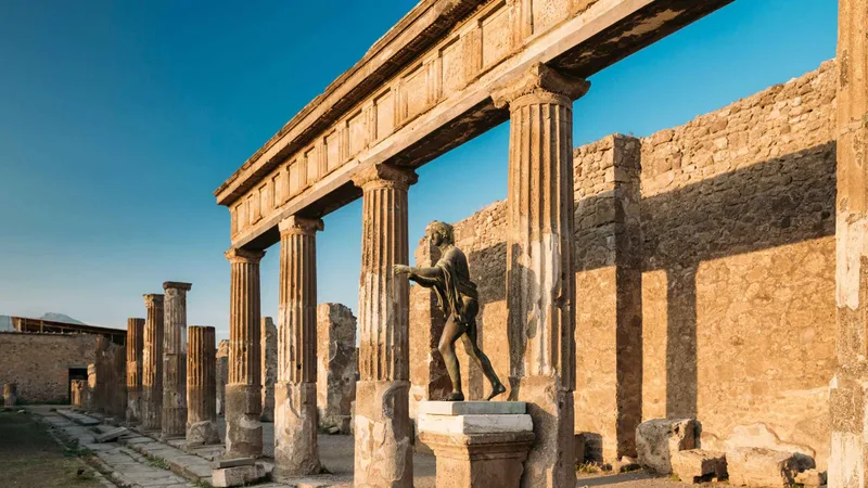 Columns and bronze statue of the Temple of Apollo, seen with the ticket-only option of Pompeii tours from Rome that add free time in Naples, Italy